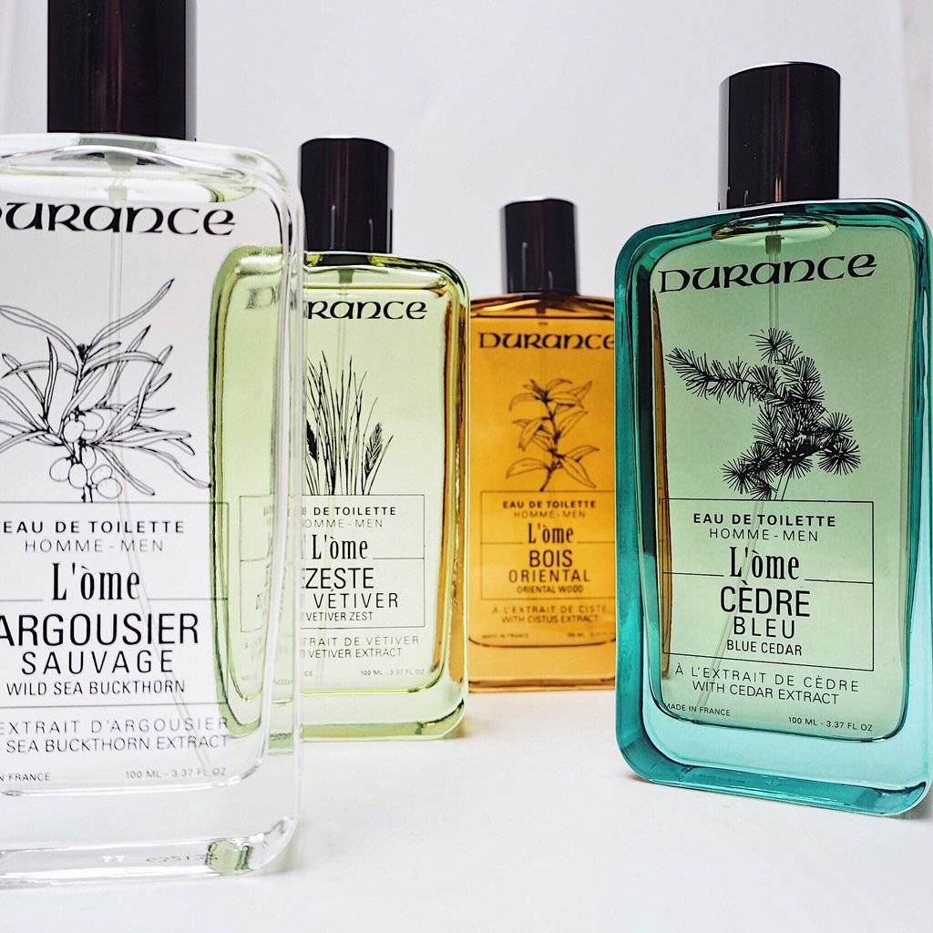 Durance, Mens L'òme Eau de Toilette fragrances for men. All clear bottles with nice illustrations, four fragrances on a white table with a white background. 