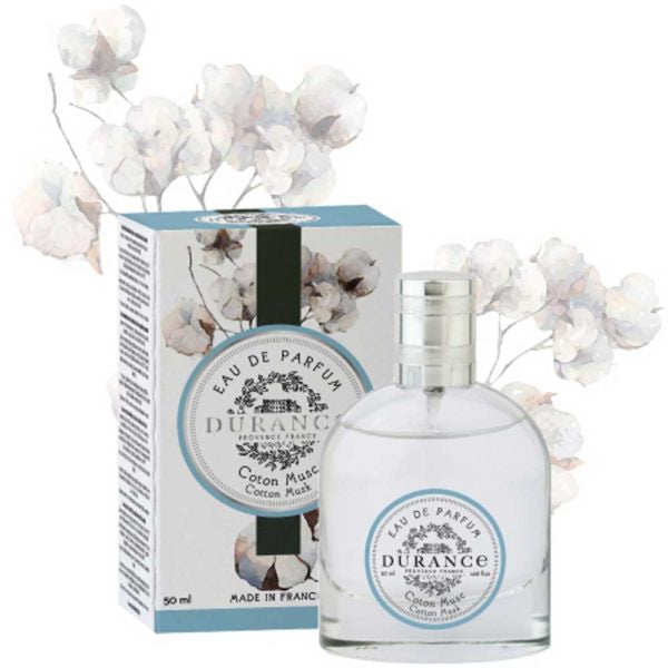 Cotton musk eau de perfume in beautiful glass bottle with silver lid. Box is also shown, blue white and black label against a delicate cotton flower water painting.