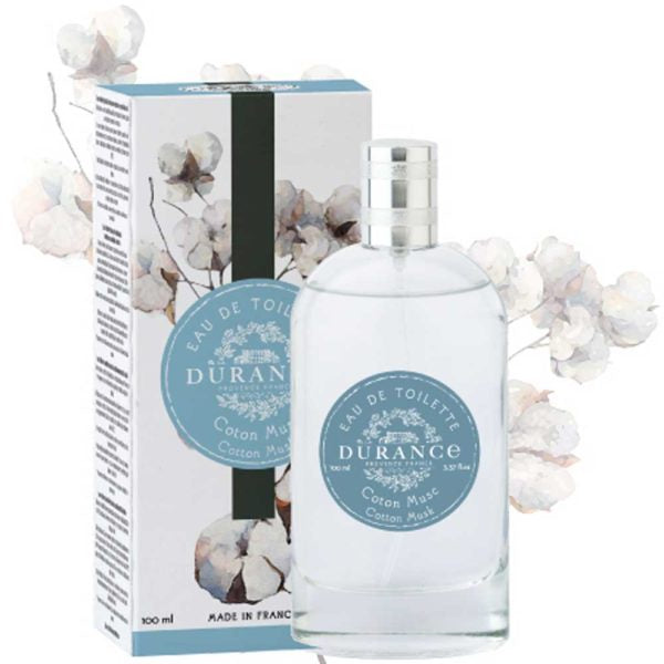 Large durance eau de toilette cotton musk perfume against a white backdrop with delicate cotton flower water painting. Box is also shown with blue black and white label. 